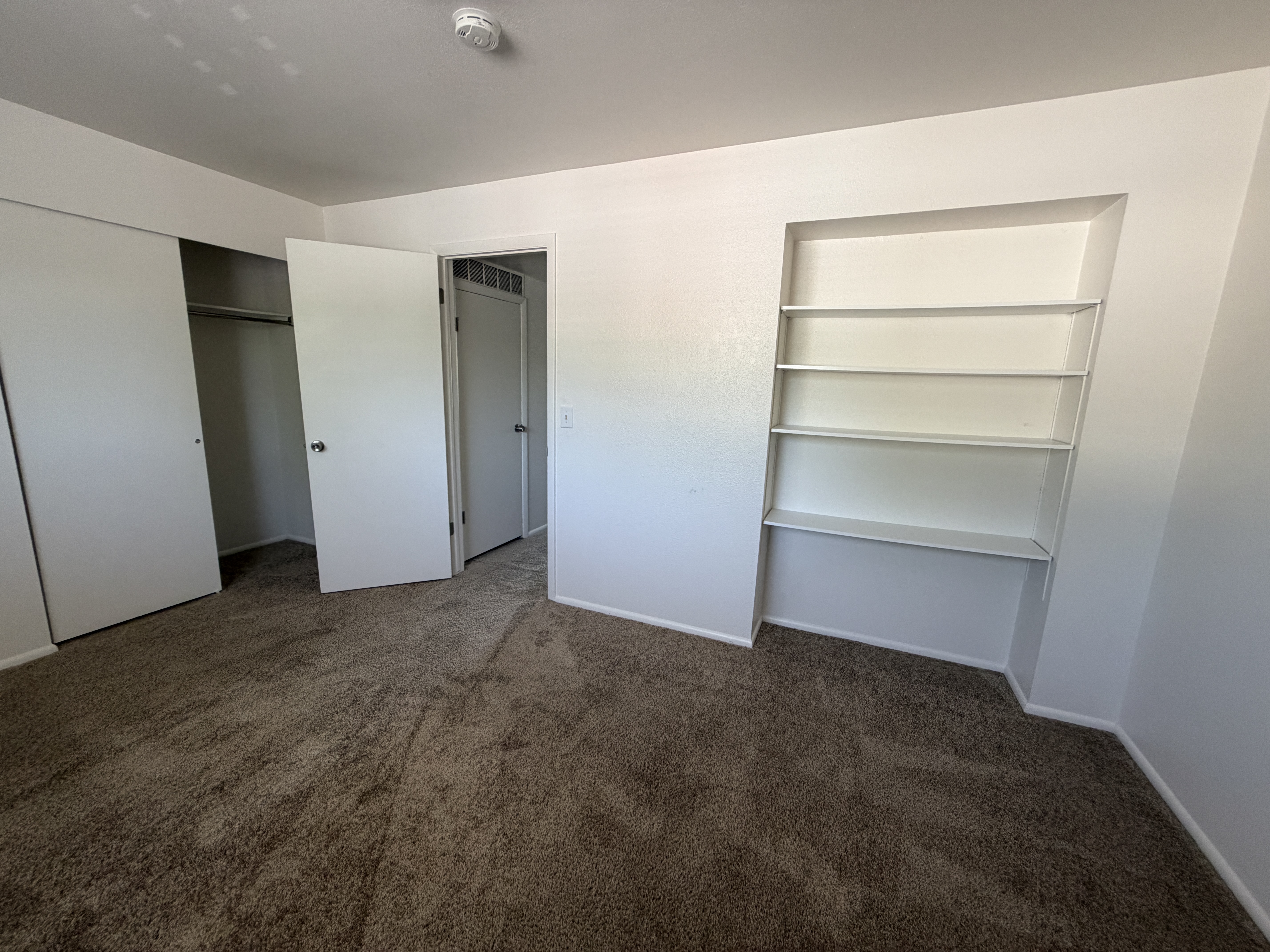 Bedroom with built-in shelving